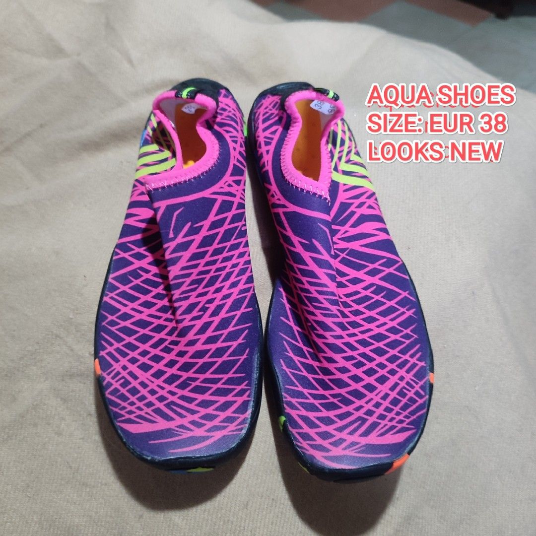 Aqua Shoes Size EUR 38 (Category: Slippers and slides) located in Baguio. Submitted by shmily01 (Listing ID 1440653207, Image 1). Description: - Aqua shoes in vibrant purple and pink. - Features a bright, colorful sole. - Ideal for water activities and beach trips. - Size: EUR 38. - Condition: Looks new. #aquashoes #watershoes.