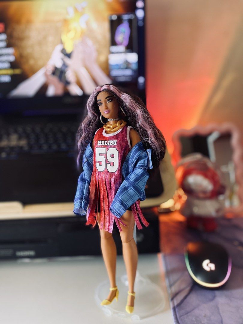 Barbie Extra #13 (Category: Kids Toys) located in Quezon City. Submitted by micah0920 (Listing ID 1440722972, Image 1). Description: - Barbie doll in sporty Malibu 59 outfit - Long, wavy purple-streaked hair - Gold chain necklace - Fringed top - Blue plaid jacket - Yellow heels - Ideal for collectors and play.