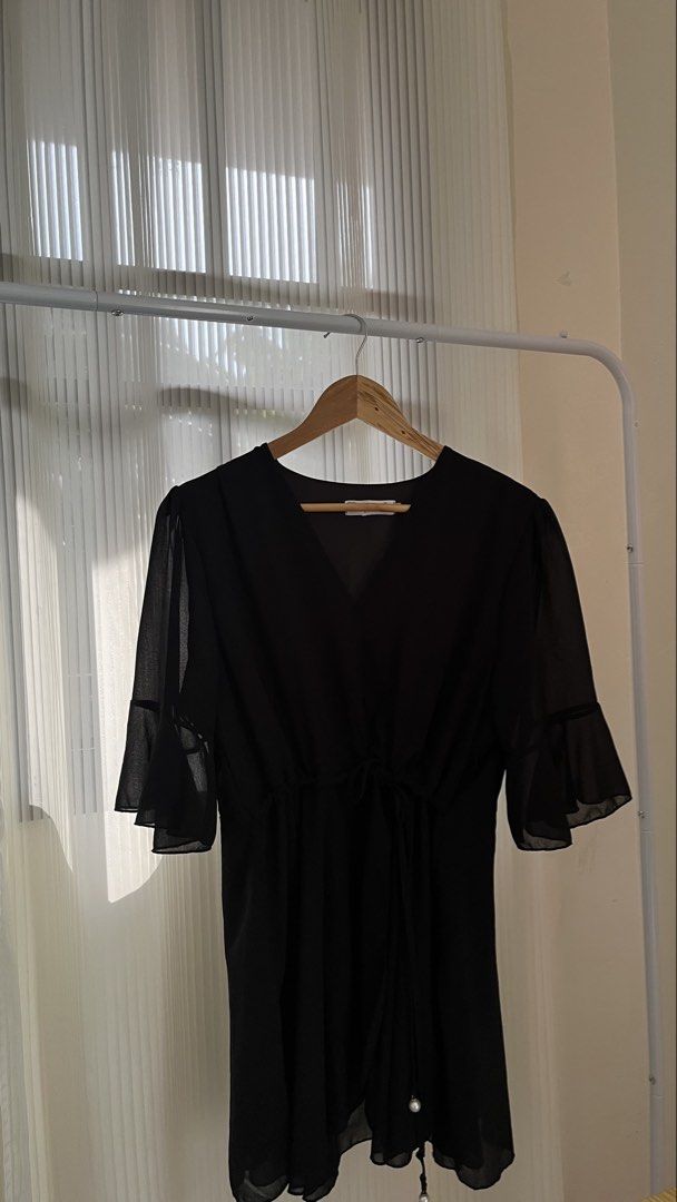 Black Dress (Category: Blouses) located in Manila. Submitted by emilyccach11277 (Listing ID 1440701205, Image 2). Description: - Chic black chiffon blouse - Flattering V-neckline with adjustable tie waist - Elegant, slightly sheer bell sleeves - Subtle pearl accent on the tie - Versatile for dressing up or down.