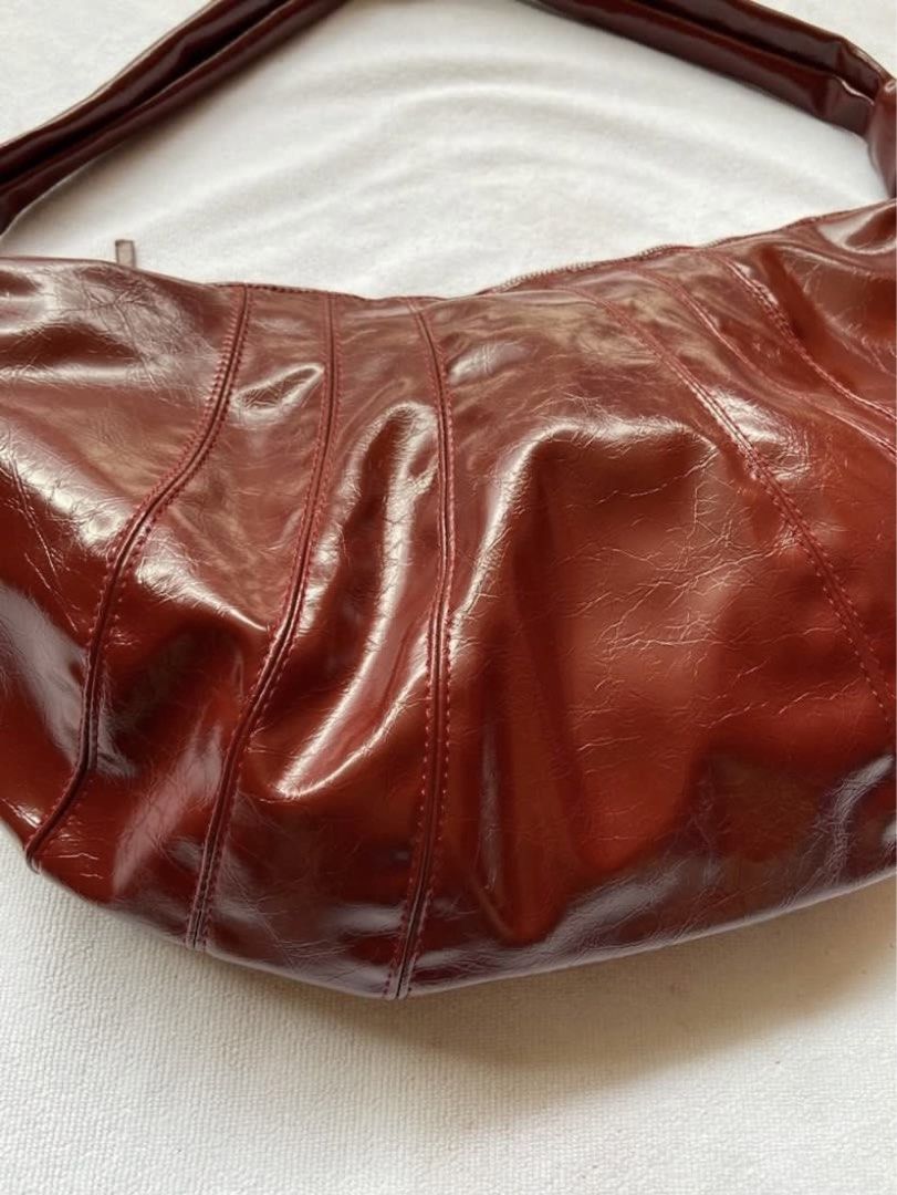 Boho/dumpling bag (Category: Shoulder Bags) located in Makati City. Submitted by ullox (Listing ID 1440683228, Image 2). Description: blood red PU leather shoulder bag. Slouchy crescent shape with knotted strap and zipper closure. Perfect for daily use. LasPiñas loc Gcash mop.