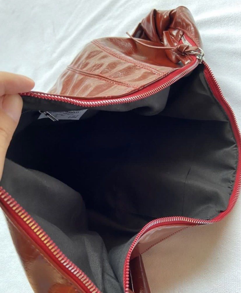Boho/dumpling bag (Category: Shoulder Bags) located in Makati City. Submitted by ullox (Listing ID 1440683228, Image 3). Description: blood red PU leather shoulder bag. Slouchy crescent shape with knotted strap and zipper closure. Perfect for daily use. LasPiñas loc Gcash mop.