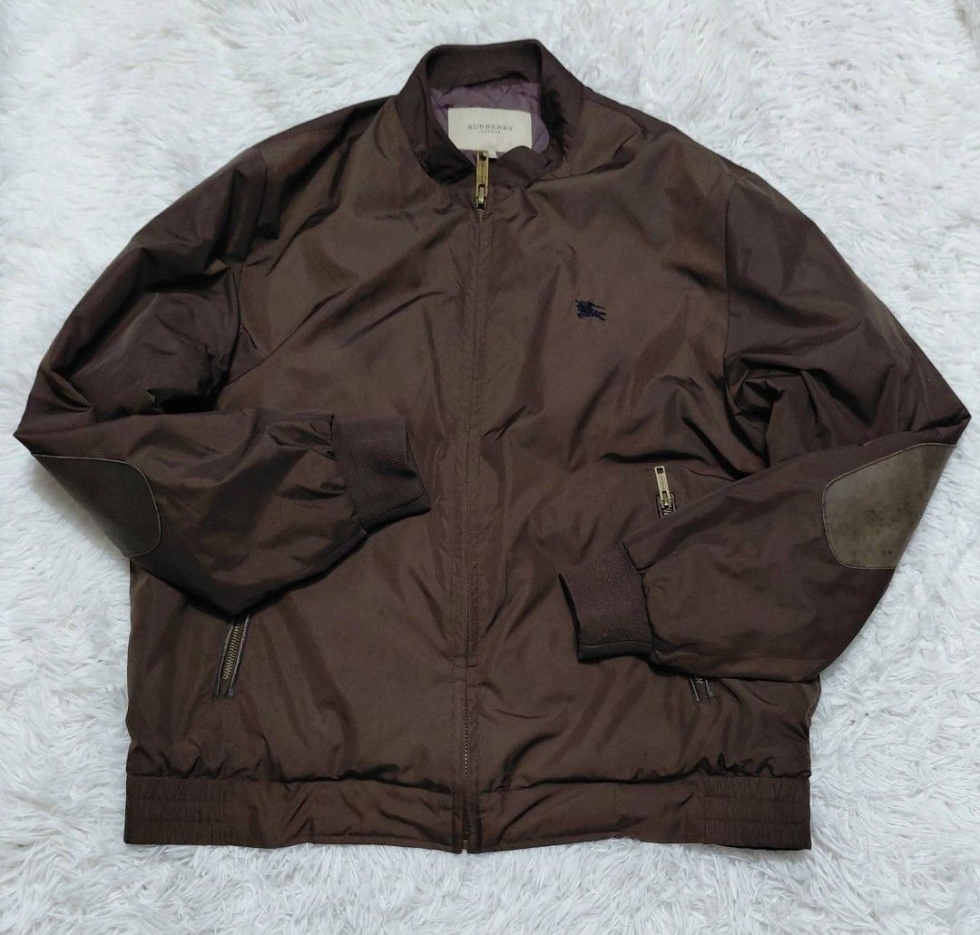 Burberry Brown Bomber Jacket with Nova Check Lining (Category: Coats, Jackets and Outerwear) located in Baguio. Submitted by lotus_blossom (Listing ID 1440651425, Image 1). Description: - Authentic Burberry bomber jacket - Iconic Nova Check lining - Durable elbow patches - Two front zip pockets - Elasticated cuffs and hem - Ideal for layering.
