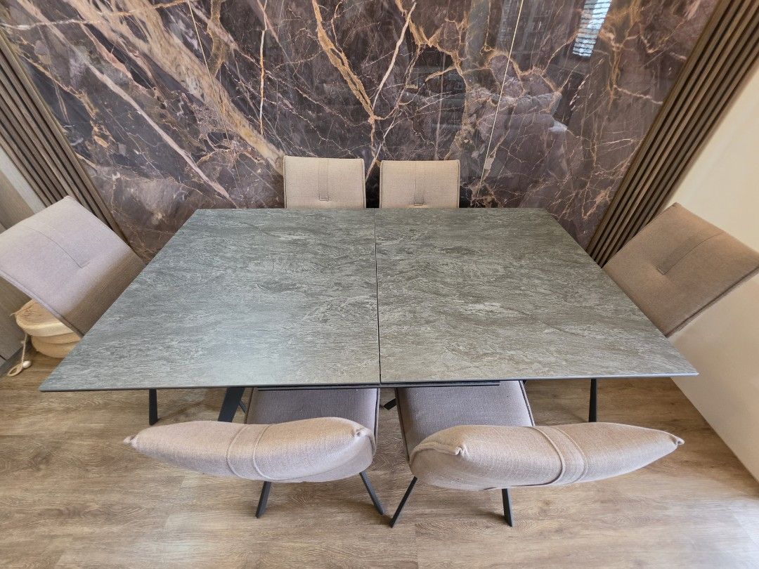 Ceremic Extendable Dining Table (Category: Tables & Sets) located in Singapore. Submitted by lucienhkl (Listing ID 1440674982, Image 1). Description: Dimensions: Before Extend L160cm x B90cm After Extend L220cm x B90cm - Modern dining table with a stylish stone-look tabletop. - Extendable design, shown in its longer configuration. - Comfortably seats 6-8 people. - Features sturdy black metal legs. - Ideal for family meals and entertaining guests.