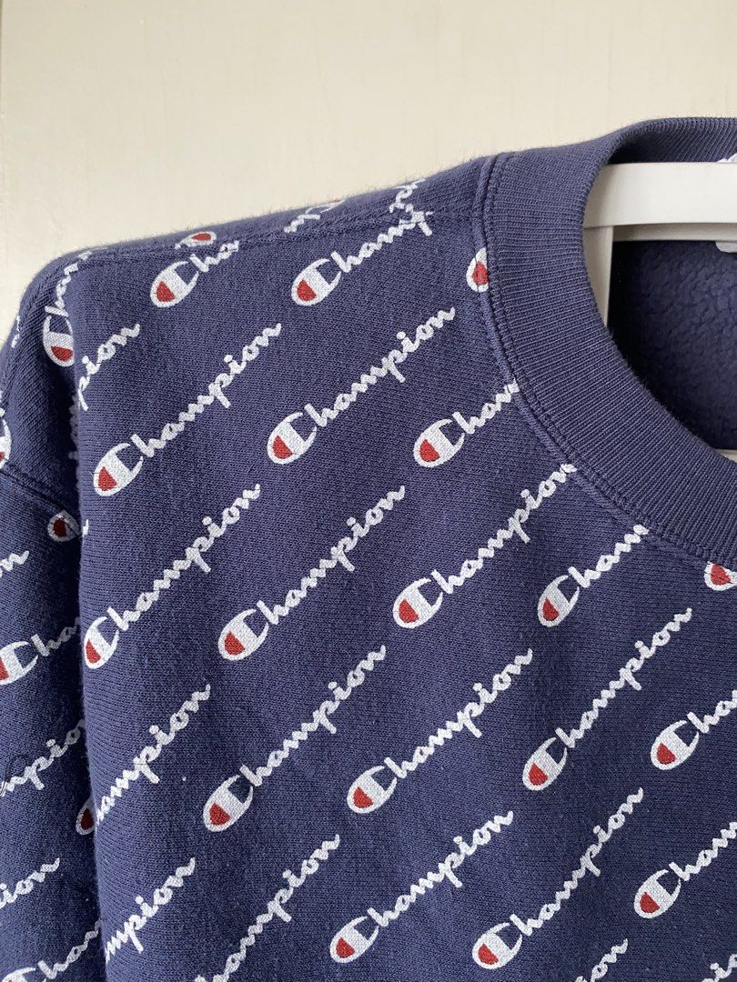 Champion Reverse Weave All Over Logo Cropped Sweatshirt Navy Blue (Category: Longsleeves) located in Quezon City. Submitted by closet-cleanup (Listing ID 1440657015, Image 2). Description: - Navy blue Champion sweatshirt - All-over repeating 'Champion' logo print in white and red - Crew neck, long sleeves - Cropped style - Size: Large oversized fit 💳 Payment: Maya, GCash, BPI 📦 Shipping: Gogo Express or J&T Express, Grab or Lalamove (shouldered