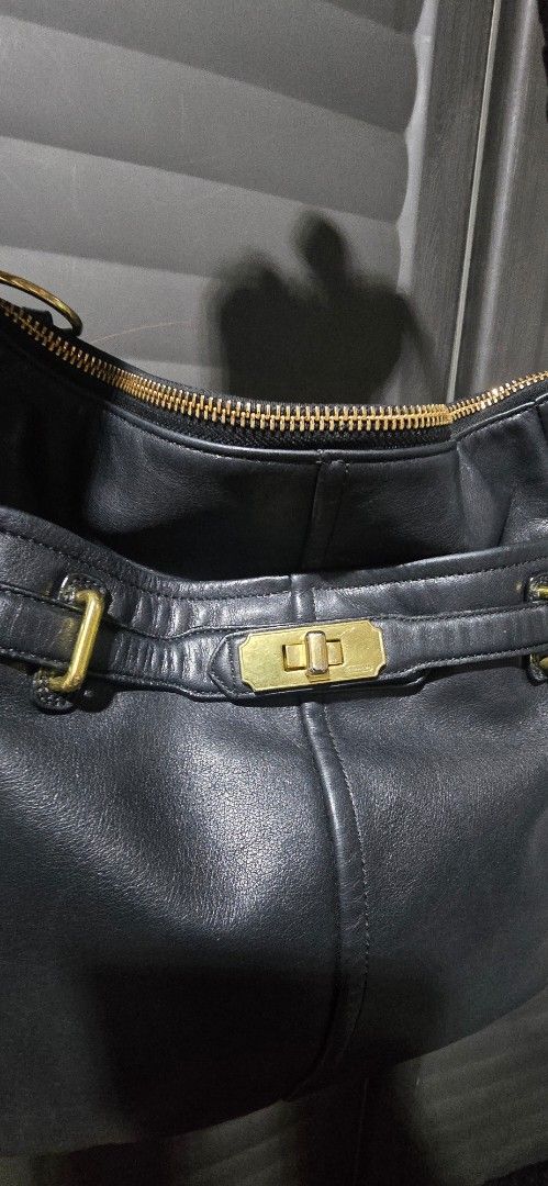 Coach Leather Shoulder Bag with Gold Hardware (Category: Luxury Bags & Wallets) located in Manila. Submitted by muliph (Listing ID 1440674720, Image 2). Description: - Genuine black leather shoulder bag - Elegant gold hardware details - Secure zip closure - Adjustable strap with buckles for a custom fit - Ample interior space for your essentials - Ideal for everyday wear.