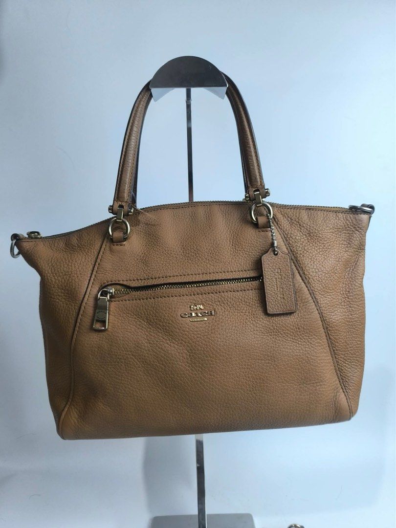 Coach Pebble Leather Satchel Bag Tan (Category: Shoulder Bags) located in Subic. Submitted by amorscollection (Listing ID 1440724807, Image 2). Description: - Coach tan pebble leather satchel - Top handles and detachable crossbody strap - Front zip pocket - Main zip compartment - Gold hardware details - Includes Coach hangtag - Ideal everyday bag Issue - inside creed .