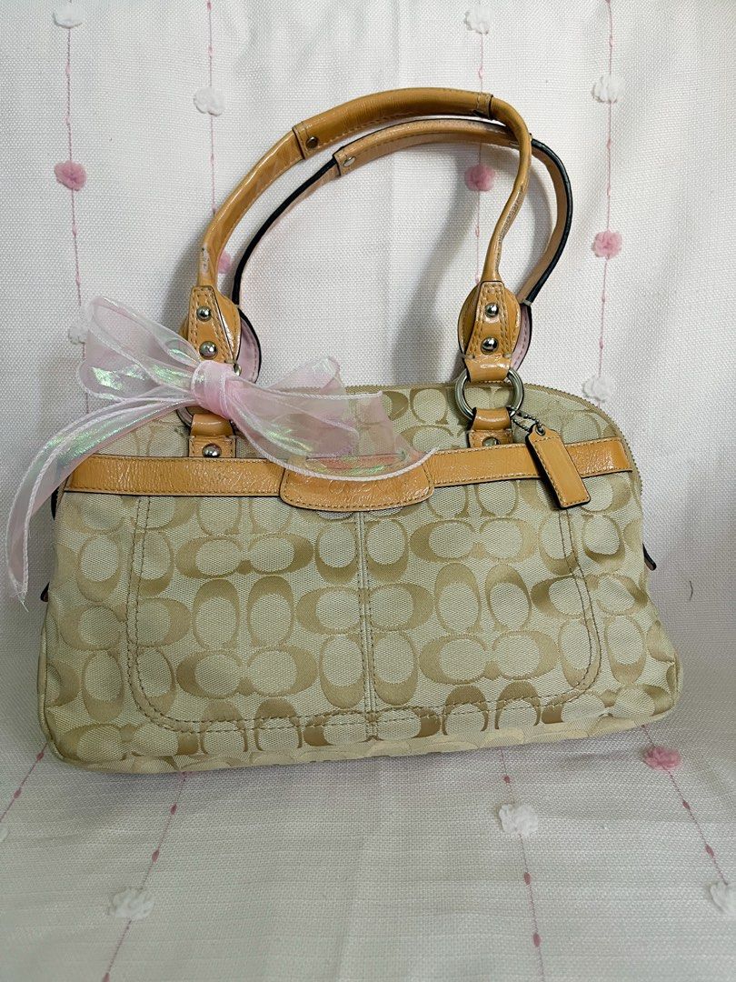 Coach PENELOPE Canvas FREE SF (Category: Luxury Bags & Wallets) located in Manila. Submitted by dj_mj (Listing ID 1440616935, Image 2). Description: - Authentic Coach monogram canvas handbag - Signature tan and beige 'C' pattern - Tan leather trim and handles - Light pink satin interior - Interior leather tag with serial number: L1049-F14695 - Secure zipper closure - Comes with a decorative ribbon tied to the handle.