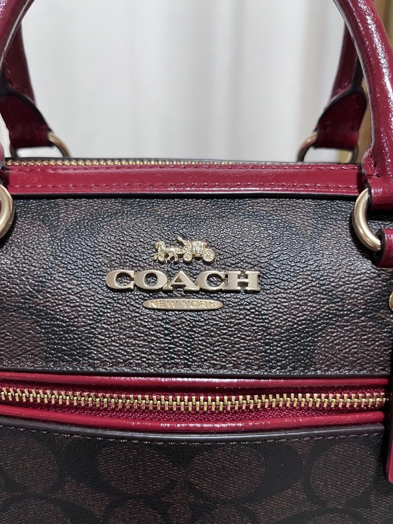 Coach Rowan (Category: Luxury Bags & Wallets) located in Nagcarlan. Submitted by prelovedbymayen (Listing ID 1440603756, Image 2). Description: Coach Rowan Satchel in Signature Canvas, featuring a classic brown monogram coated canvas paired with vibrant red leather trim and handles. ✅💯Authentic ✅Pre-loved from Japan ✅with minimal issue on strap and handle .