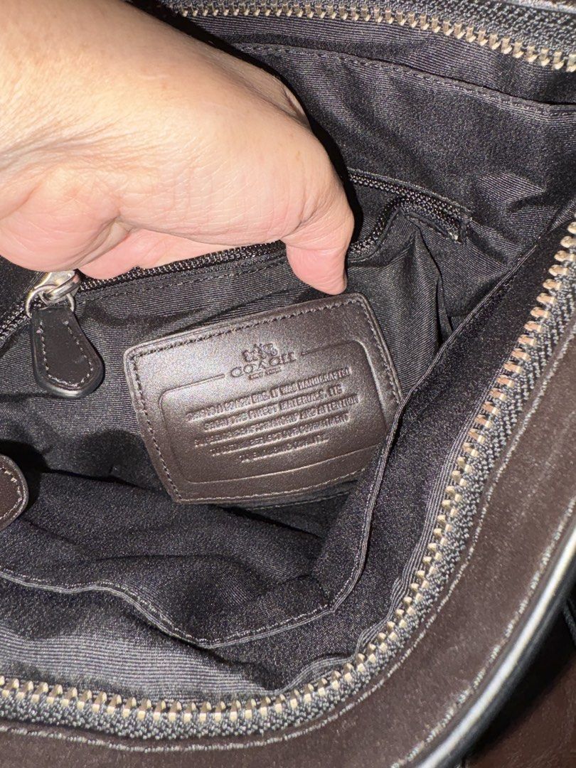 Coach Signature Monogram Crossbody Bag (Category: Sling Bags) located in Paranaque City. Submitted by jnetpreloveditems (Listing ID 1440653913, Image 3). Description: - Coach crossbody bag - Signature monogram print - Dark brown and black colorway - Genuine leather trim and strap - Secure zipper closure - Multiple interior compartments for organization - Ideal for everyday use, fits phone, wallet, keys, and other essentials.