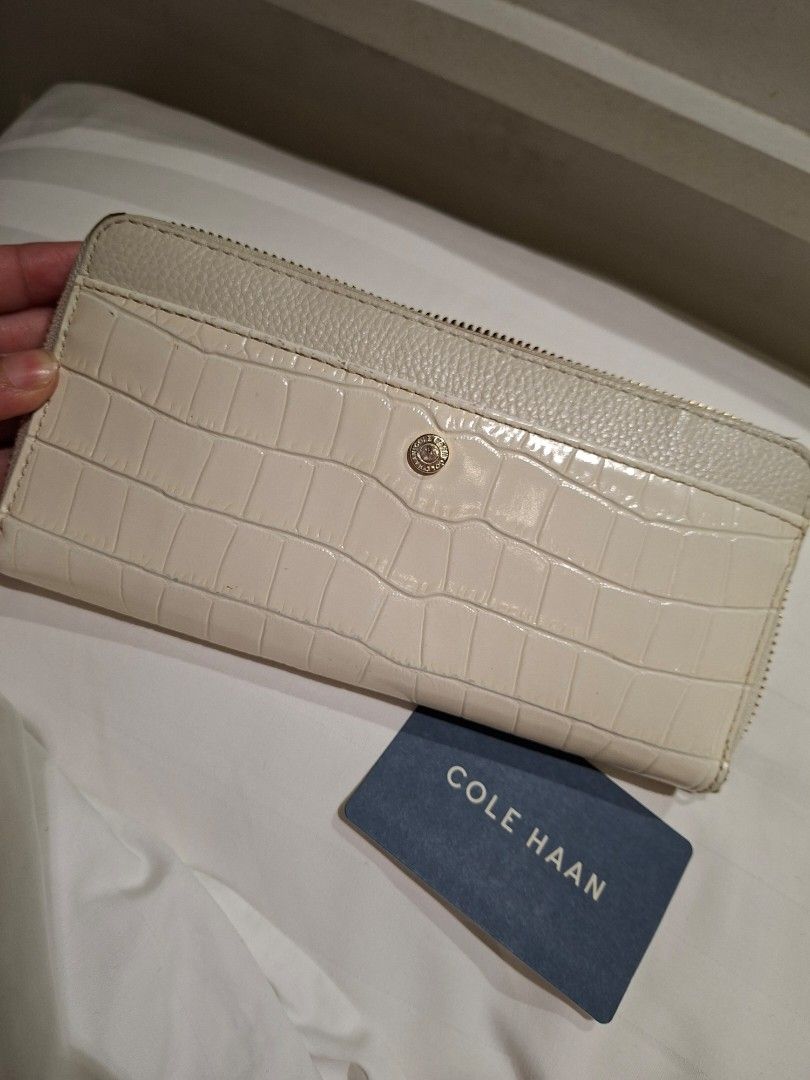 Cole Haan White Crocodile Embossed Zip Around Wallet (Category: Wallets & Card holders) located in Manila. Submitted by pupsik.tan (Listing ID 1440720942, Image 1). Description: - White zip-around wallet by Cole Haan - Crocodile embossed texture on exterior - Multiple card slots and compartments inside - Comes with Cole Haan authenticity card - Ideal for keeping your essentials organized.