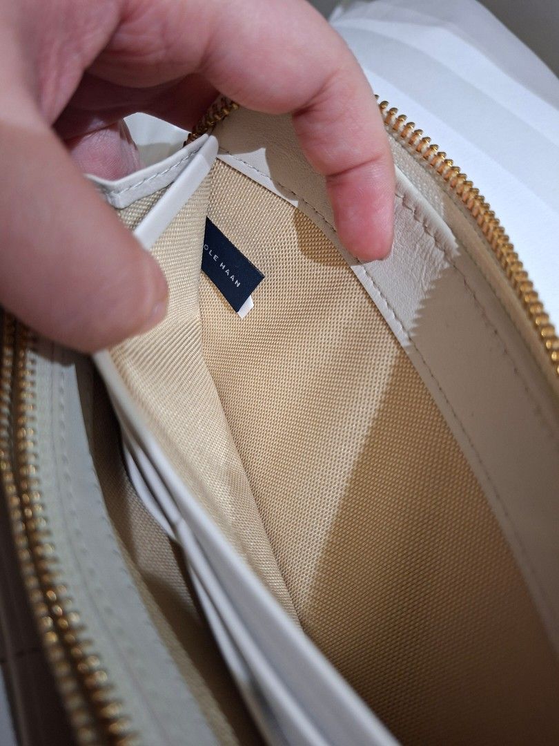 Cole Haan White Crocodile Embossed Zip Around Wallet (Category: Wallets & Card holders) located in Manila. Submitted by pupsik.tan (Listing ID 1440720942, Image 3). Description: - White zip-around wallet by Cole Haan - Crocodile embossed texture on exterior - Multiple card slots and compartments inside - Comes with Cole Haan authenticity card - Ideal for keeping your essentials organized.