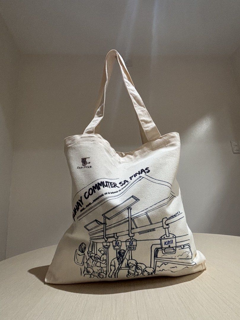 Commuters, Kaya Pa Ba? Flat Tote Bag (Category: Tote Bags) located in Makati City. Submitted by PamsCorner (Listing ID 1440644126, Image 1). Description: 👜 Commuters, Kaya Pa Ba? Flat Tote Bag For the everyday commuter, the Commuters, Kaya Pa Ba? Flat Tote Bag is more than just a carryall — it’s a relatable statement piece. Built for resilience and convenience, this tote is perfect for those navigating the hustle of city life. ✨ Key Features Zip