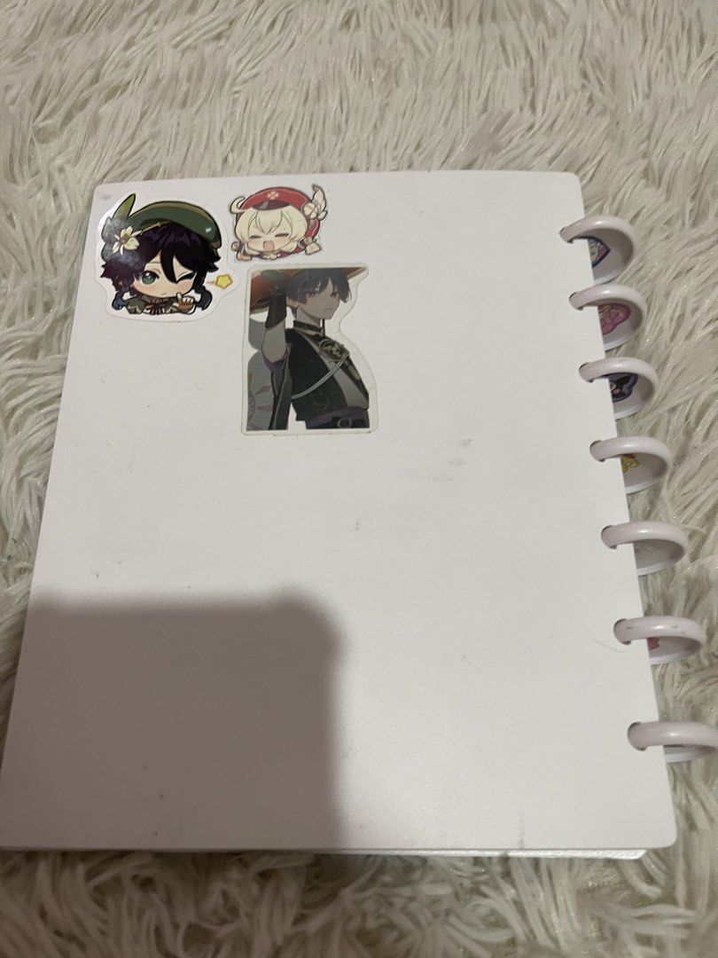 Cute Mini Notebook with Stickers & Photo Sleeves (Category: Stationery & School Supplies) located in Paranaque City. Submitted by mystic_random_vault (Listing ID 1440671352, Image 3). Description: White mini notebook or photo album. Decorated with cute stickers like flowers, rainbows, butterflies, and positive quotes. Also has some anime character stickers on the back. Comes with clear plastic sleeves inside to hold photos or cards. Great for jou
