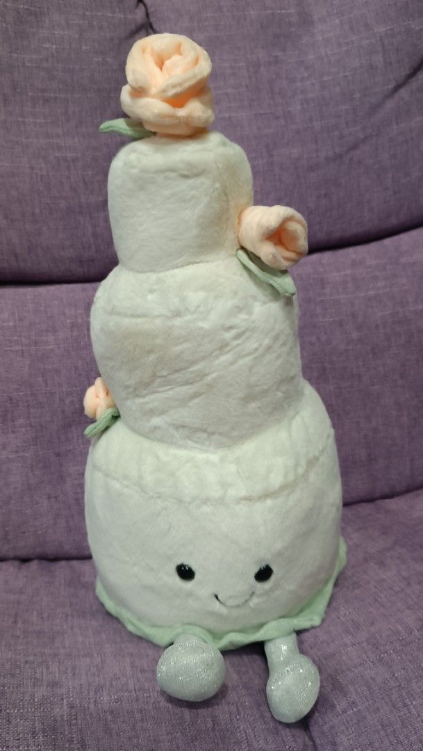 Cute Tiered Cake Plush Toy with Roses (Category: Plushies & Soft Toys) located in Quezon City. Submitted by fabricatebycp (Listing ID 1440755984, Image 1). Description: Super cute plush toy shaped like a tiered cake. It has little fabric roses on top and sides. The face is embroidered with a sweet smile. The bottom has little feet. Great for decoration or as a gift. Measures about 13 inches..
