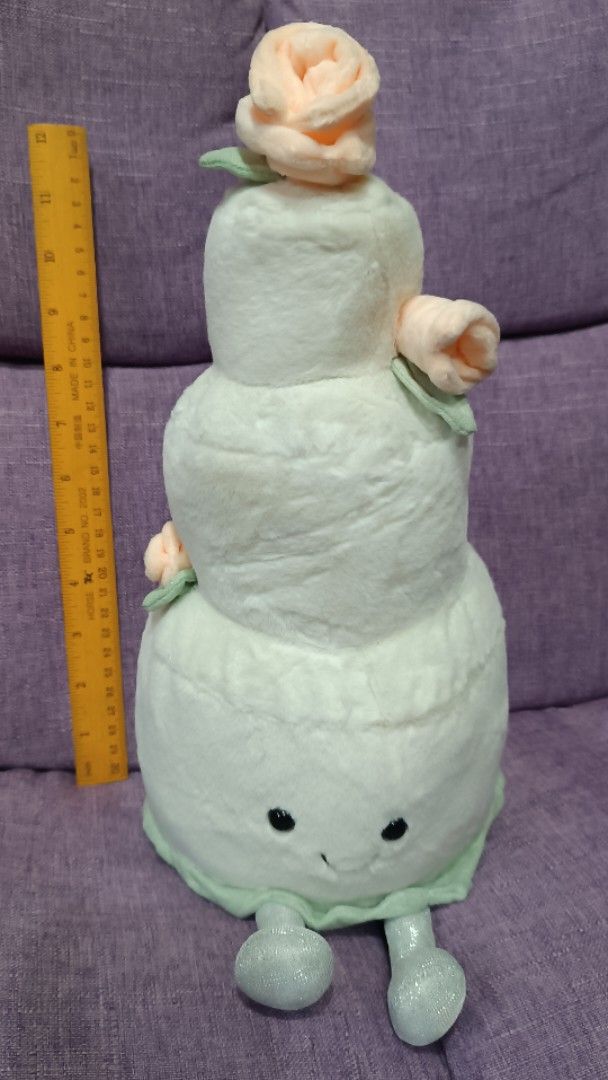 Cute Tiered Cake Plush Toy with Roses (Category: Plushies & Soft Toys) located in Quezon City. Submitted by fabricatebycp (Listing ID 1440755984, Image 3). Description: Super cute plush toy shaped like a tiered cake. It has little fabric roses on top and sides. The face is embroidered with a sweet smile. The bottom has little feet. Great for decoration or as a gift. Measures about 13 inches..
