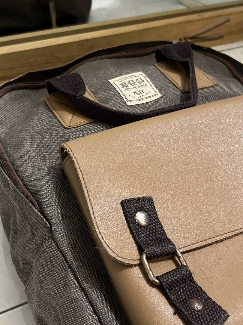EGG Marcus Backpack (Category: Backpacks) located in Malabon City. Submitted by rika_26 (Listing ID 1440615409, Image 3). Description: Color: Dark gray with beige/tan accents > Canvas-like material with leather-style front pocket > Adjustable straps and sturdy handles RFS: Decluttering .