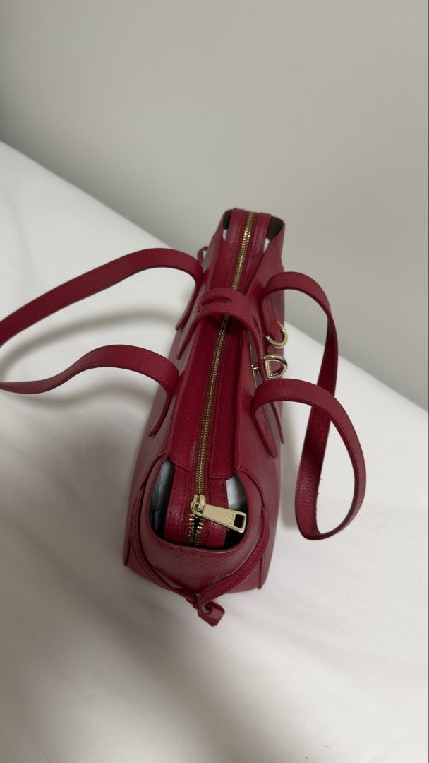 Furla Genuine Leather Shoulder Bag - Red (Category: Luxury Bags & Wallets) located in Paranaque City. Submitted by nia_2ndhand (Listing ID 1440685247, Image 3). Description: COMPLETE WITH DUST BAG AND PRICE TAG - Authentic Furla red pebbled leather tote bag - Made in Bulgaria - Genuine leather - Zip closure - Two top handles - Interior zip pocket - Interior slip pocket - Gold hardware details - Ideal for everyday use.