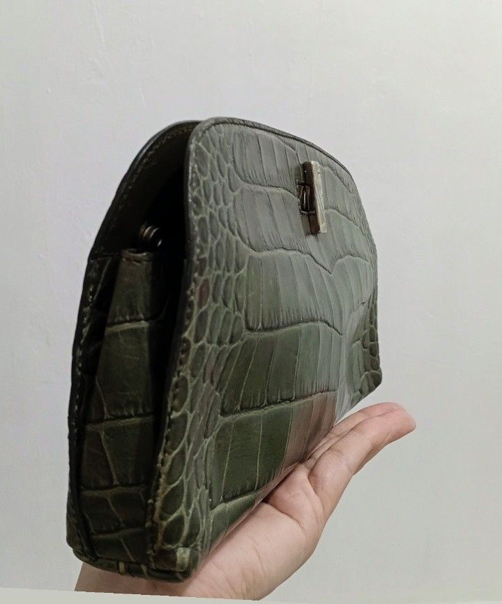 FURLA Green Crocodile Embossed Elegant Clutch (Category: Luxury Bags & Wallets) located in Navotas City. Submitted by ms.soulana (Listing ID 1440599343, Image 2). Description: PreOwned Lightly Used FURLA Croc Embossed leather Elegant green clutch Pouch - Crocodile embossed texture - Secure Silvertone clasp closure - Compact, curved shape - Ideal for evenings and special occasions - Fits phone, cards, and lipstick Sign of Used Min Rubs sa Croc Lea