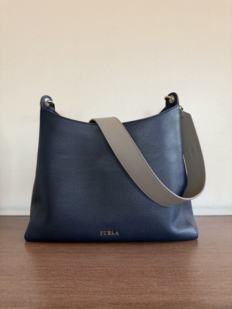 Furla Hobo Bag (2 Straps) (Category: Luxury Bags & Wallets) located in Manila. Submitted by liztan (Listing ID 1440609211, Image 1). Description: - Authentic Furla hobo bag - Deep navy blue pebbled leather - Detachable and adjustable grey strap - Gold hardware accents - Spacious interior - Ideal for everyday use.