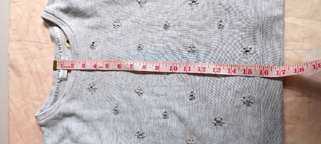 Grey Embellished Long Sleeve Sweater (Category: Longsleeves) located in Davao. Submitted by fabmegashop (Listing ID 1440688065, Image 3). Description: - Light grey sweater - Textured pattern - Small sparkly embellishments all over - Round neckline - Long sleeves - Measurements: Chest approx 18 inches, Sleeve length approx 17 inches - Ideal for a casual look.