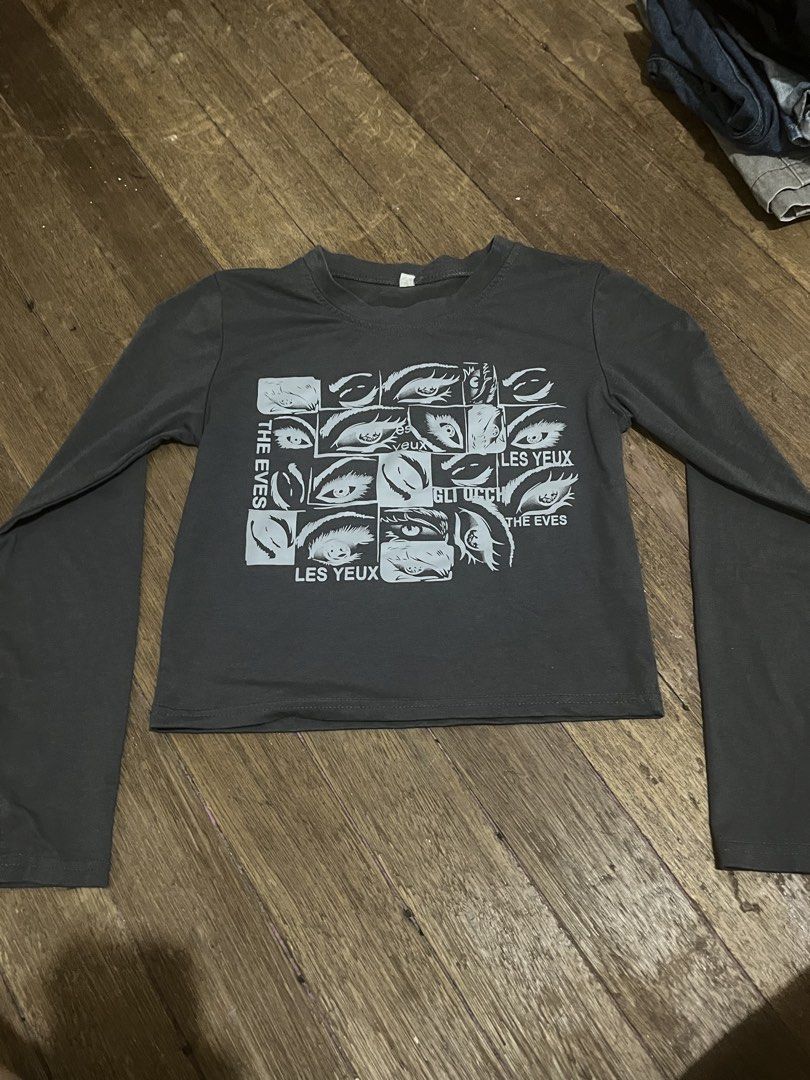 Grey Long Sleeve Crop Top with Eye Graphic (Category: Longsleeves) located in Taguig. Submitted by yvezntually (Listing ID 1440743027, Image 1). Description: - Grey long sleeve crop top - Features a graphic print of eyes and text - Flared sleeves - Estimated size: Small to Medium - Ideal for casual outfits.