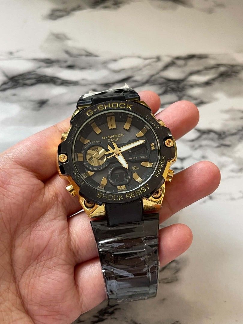 G-Shock Casio Gold Black Shock Resist Watch MOD (Category: Men's Watches) located in Pasig City. Submitted by gheo0025 (Listing ID 1440725116, Image 1). Description: - G-Shock Watch - Gold and Black Accents - Shock Resist Feature - Analog Display with Digital Sub-dial - Metal Strap - Ideal for Everyday Wear or Sports - Selling with can and paper bag.