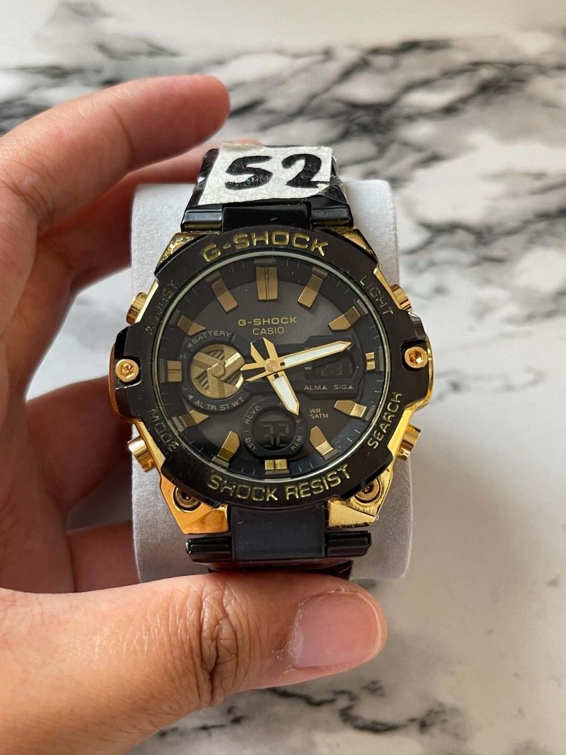 G-Shock Casio Gold Black Shock Resist Watch MOD (Category: Men's Watches) located in Pasig City. Submitted by gheo0025 (Listing ID 1440725116, Image 2). Description: - G-Shock Watch - Gold and Black Accents - Shock Resist Feature - Analog Display with Digital Sub-dial - Metal Strap - Ideal for Everyday Wear or Sports - Selling with can and paper bag.