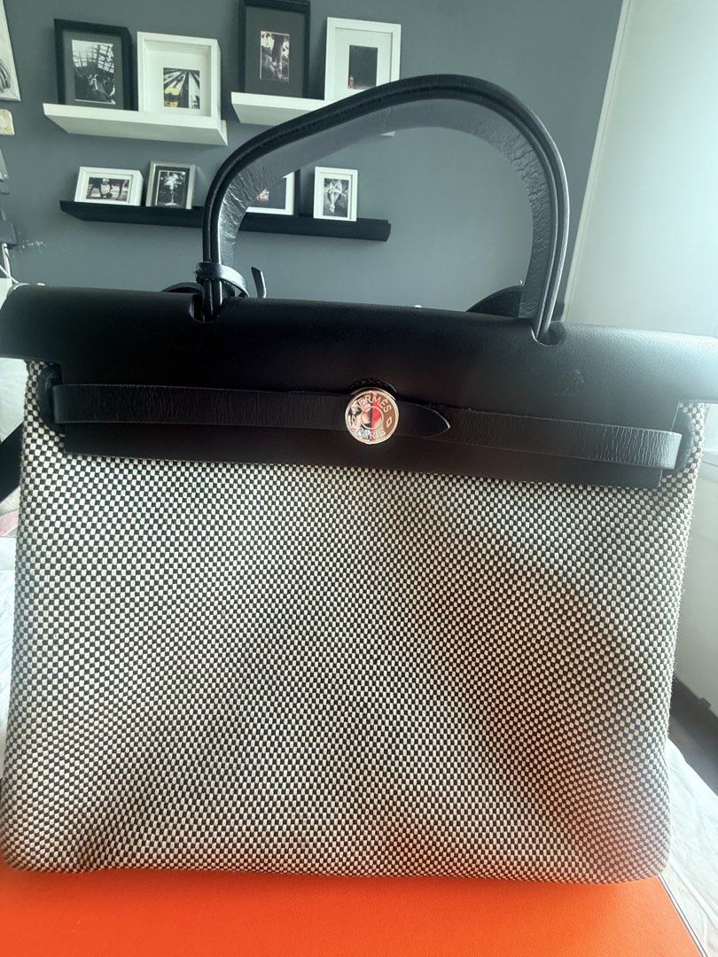 Hermes her bag (Category: Luxury Bags & Wallets) located in Taguig. Submitted by tipssy2 (Listing ID 1440578518, Image 2). Description: - Authentic Hermes Her bag - Black leather top and handles - Canvas body with checkered pattern - Comes with lock and keys - Includes original dust bag - Original orange Hermes box included - lightly used bought in October 2025 in Ireland .