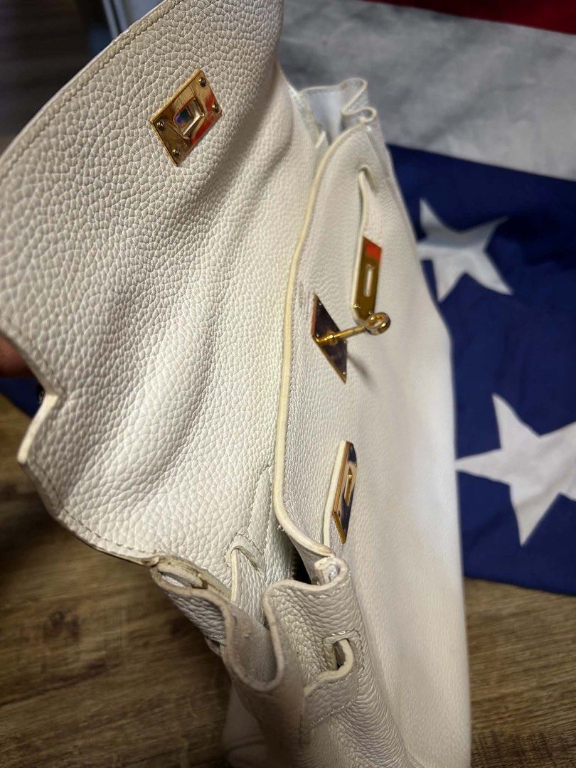 Hermes White Leather Handbag with Scarf Accent (Category: Luxury Bags & Wallets) located in Quezon City. Submitted by ozzy04 (Listing ID 1440688651, Image 3). Description: - Elegant white leather handbag - Luxurious gold hardware details - Adorned with a vibrant, colorful scarf on the handle - Interior stamped 'Hermes Paris Made in France' - Classic and timeless bag style - Minor marks present on the bottom exterior.