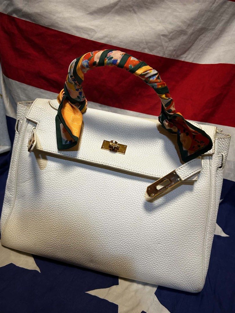 Hermes White Leather Handbag with Scarf Accent (Category: Luxury Bags & Wallets) located in Quezon City. Submitted by ozzy04 (Listing ID 1440688651, Image 1). Description: - Elegant white leather handbag - Luxurious gold hardware details - Adorned with a vibrant, colorful scarf on the handle - Interior stamped 'Hermes Paris Made in France' - Classic and timeless bag style - Minor marks present on the bottom exterior.