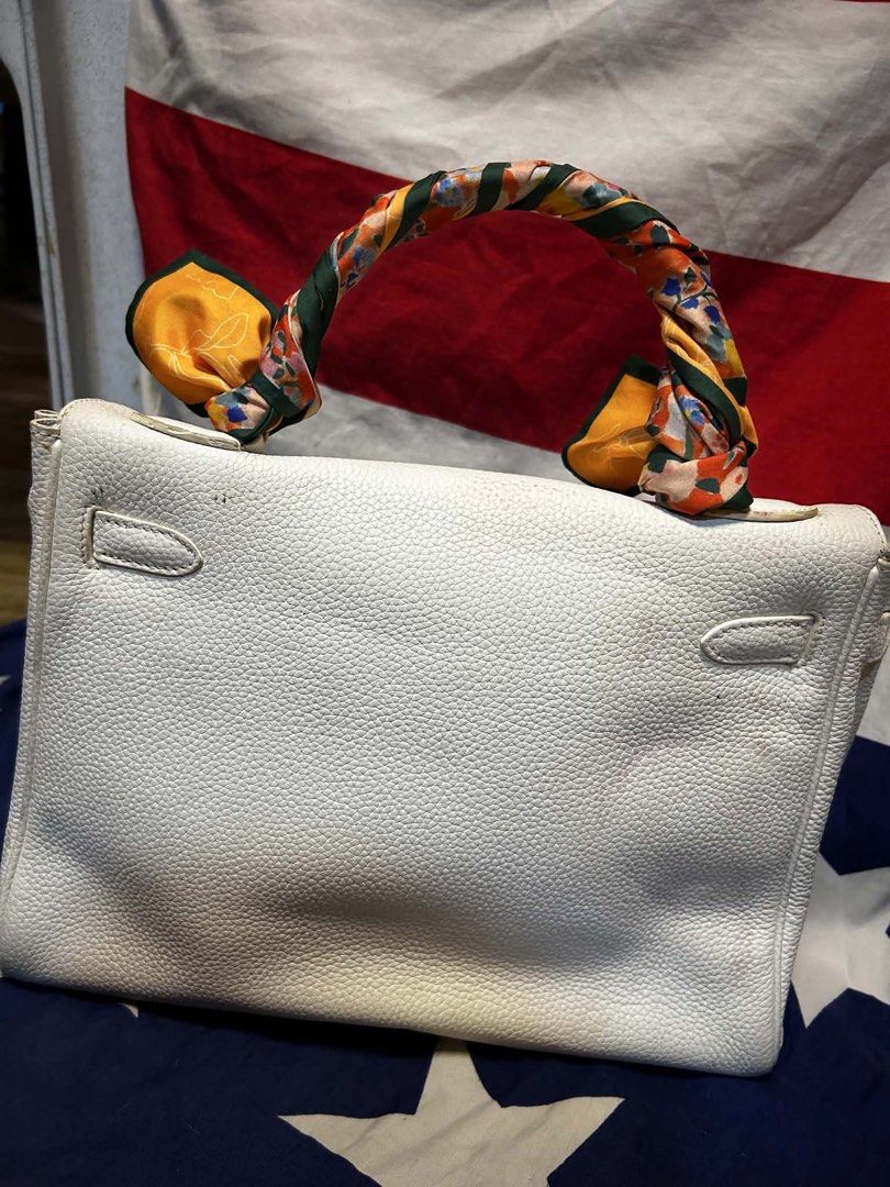 Hermes White Leather Handbag with Scarf Accent (Category: Luxury Bags & Wallets) located in Quezon City. Submitted by ozzy04 (Listing ID 1440688651, Image 2). Description: - Elegant white leather handbag - Luxurious gold hardware details - Adorned with a vibrant, colorful scarf on the handle - Interior stamped 'Hermes Paris Made in France' - Classic and timeless bag style - Minor marks present on the bottom exterior.