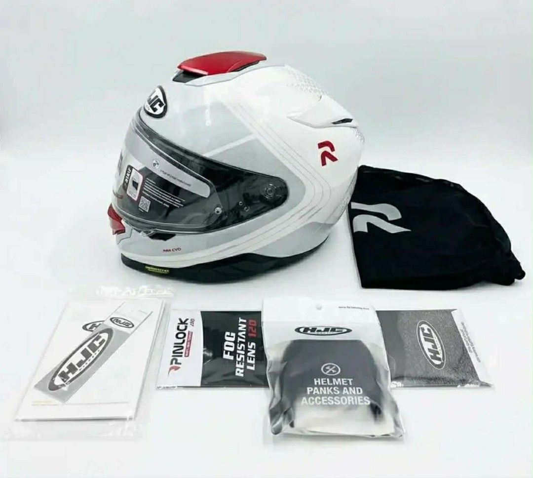 HJC RPHA 71 Motorcycle Helmet with Accessories (Category: Helmets and other Riding Gears) located in Manila. Submitted by quick.jerieme (Listing ID 1440634045, Image 3). Description: - HJC RPHA 71 Helmet - Color: White with red accents and RPHA branding - Includes: Helmet bag, Pinlock visor insert, and other HJC accessories - Ideal for motorcycle riders.