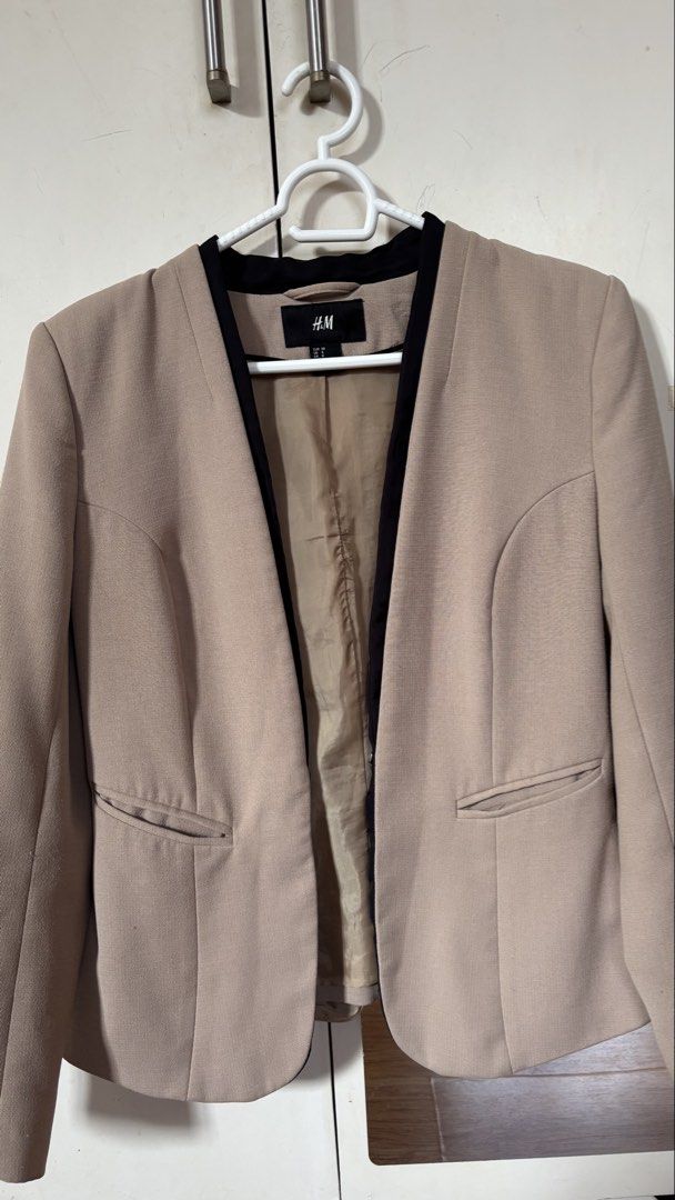 H&M Beige Collarless Blazer with Black Trim (Category: Coats, Jackets and Outerwear) located in Calamba. Submitted by reducereuserecycle. (Listing ID 1440614860, Image 3). Description: - Beige blazer from H&M - Collarless design with black trim - Two front pockets - Fully lined interior - Perfect for dressing up or down - Easy to pair with various outfits.