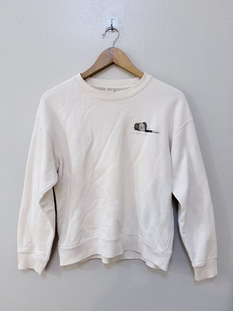 KAWS x UNIQLO Sweatshirt Off White Small (Category: Coats, Jackets and Outerwear) located in Rizal. Submitted by arkivekkk (Listing ID 1440758318, Image 1). Description: In good condition, just need ironing.