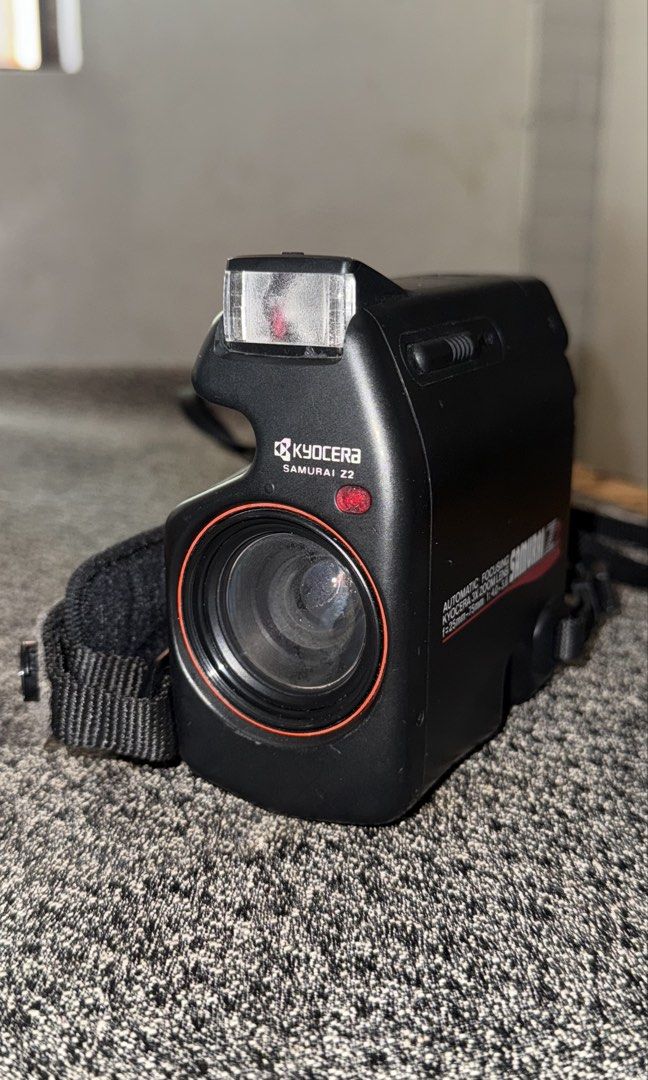 Kyocera Samurai Z2 (Category: Cameras) located in Cainta. Submitted by jmreyezzz (Listing ID 1440228355, Image 1). Description: - Kyocera Samurai Z2 film camera - Half-frame 35mm film - Built-in flash for convenience - Comes with original hand strap - Has haze in lens (better to have it cleaned by a professional) - lens cap included - No battery included - Ideal for film photography enthusiasts - Ideal for capturing memories Note: This is an old 