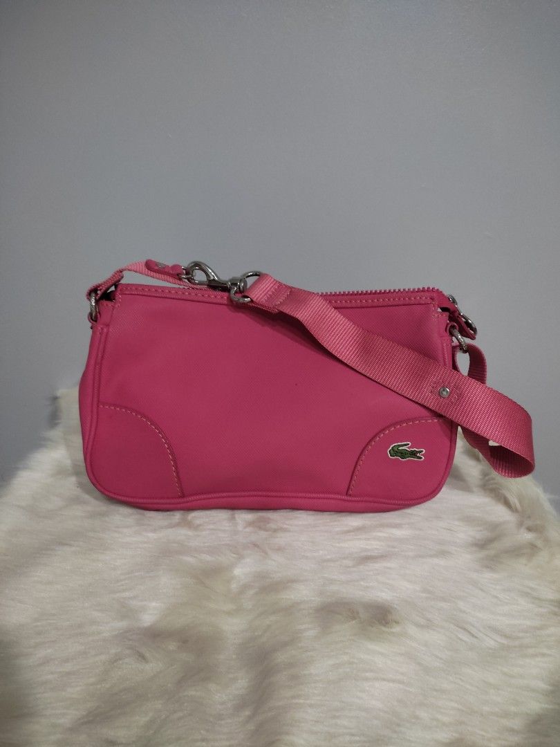 Lacoste Pink Nylon Crossbody Bag (Category: Cross-body Bags) located in Subic. Submitted by mirabrie (Listing ID 1440737975, Image 1). Description: - Cute pink Lacoste bag - Made of durable nylon material - Main zippered compartment - Inner pocket for organization - Adjustable strap for comfortable wear - Small and compact design - Ideal for everyday use or travel.