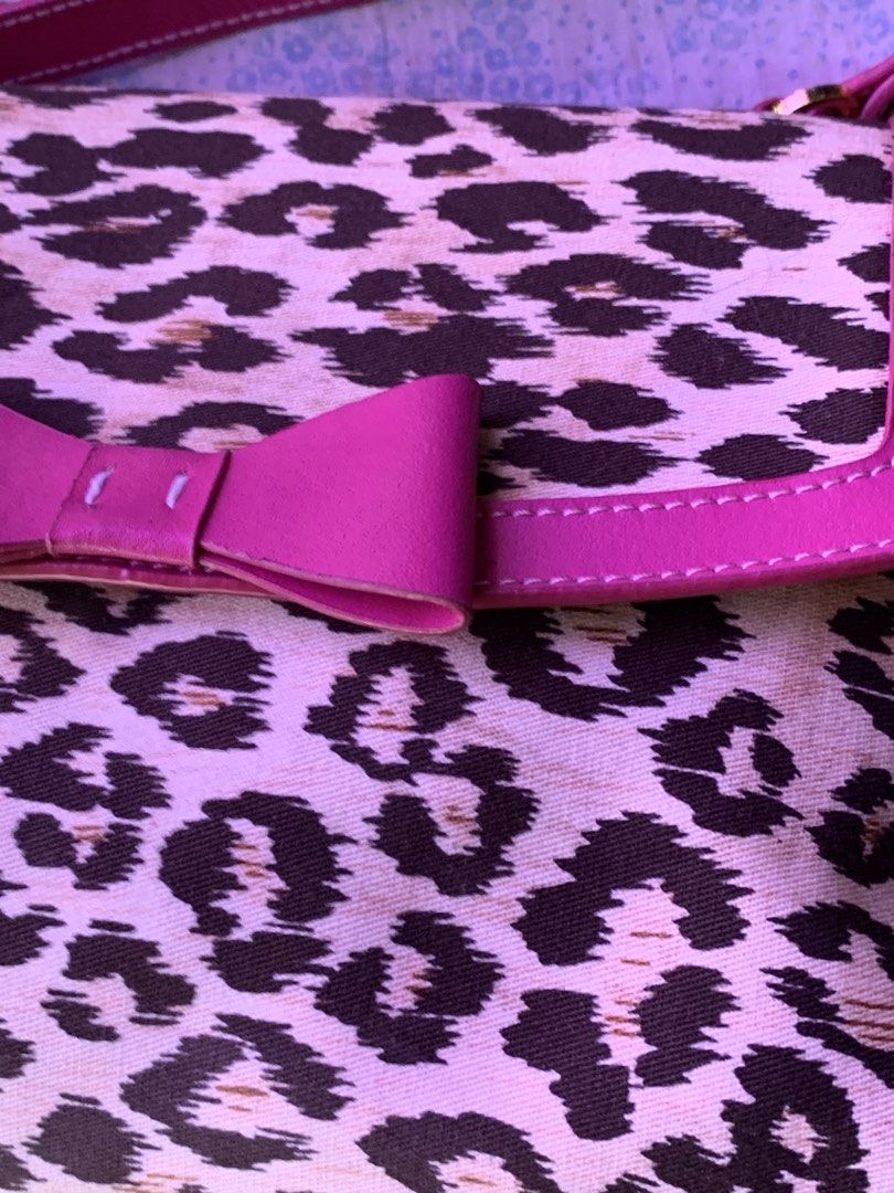 Leopard Print Handbag with Pink Bow and Trim (Category: Shoulder Bags) located in Naga. Submitted by t.nicole_revilla (Listing ID 1440619903, Image 3). Description: - Adorable leopard print handbag - Features bright pink trim and a sweet bow detail - Interior lined in pink satin - Secure zipper closure - Comfortable pink handle - Perfect for adding a fun accent to your look.