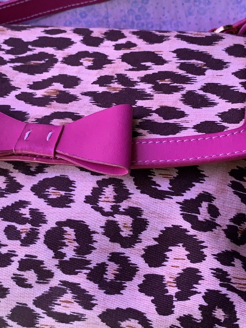 Leopard Print Handbag with Pink Bow and Trim (Category: Shoulder Bags) located in Naga. Submitted by t.nicole_revilla (Listing ID 1440619903, Image 2). Description: - Adorable leopard print handbag - Features bright pink trim and a sweet bow detail - Interior lined in pink satin - Secure zipper closure - Comfortable pink handle - Perfect for adding a fun accent to your look.