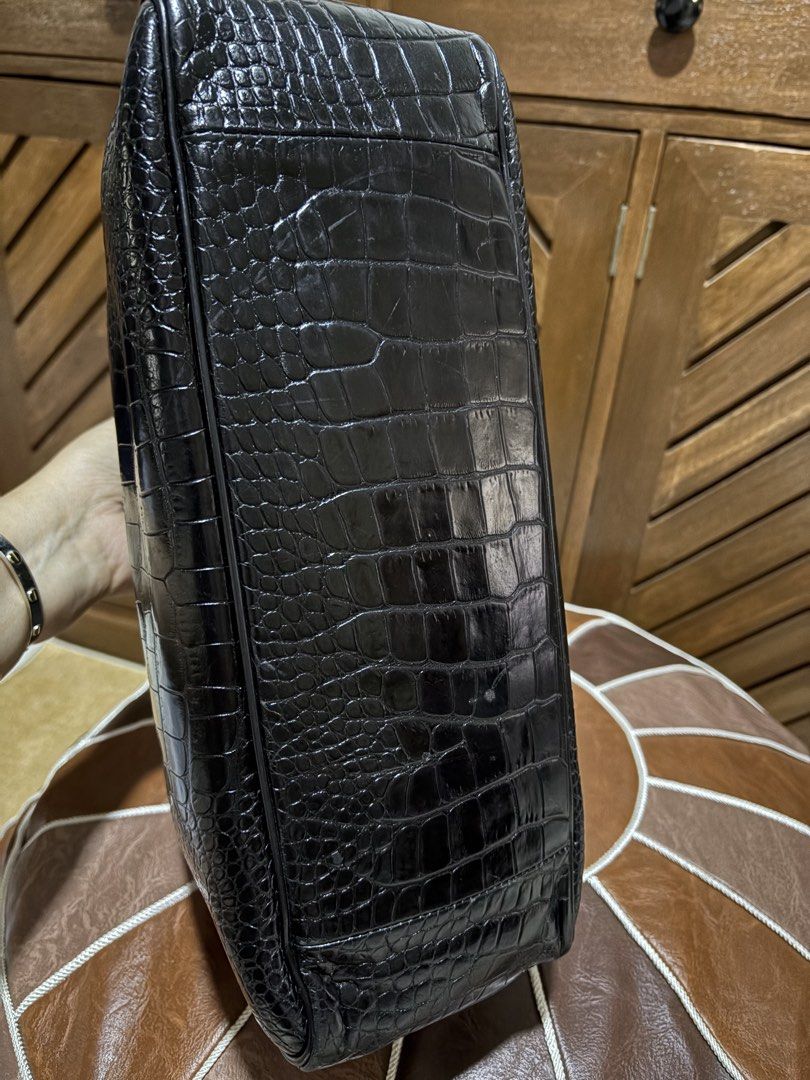 Longchamp Black Crocodile Embossed Leather Tote Bag (Category: Luxury Bags & Wallets) located in Paranaque City. Submitted by jnetpreloveditems (Listing ID 1440653517, Image 2). Description: - Luxurious black leather tote bag - Elegant crocodile embossed finish - Sturdy top handles for comfortable carrying - Secure central clasp closure - Surprise butterfly print interior lining - Structured design for a polished look - Versatile for daily errand