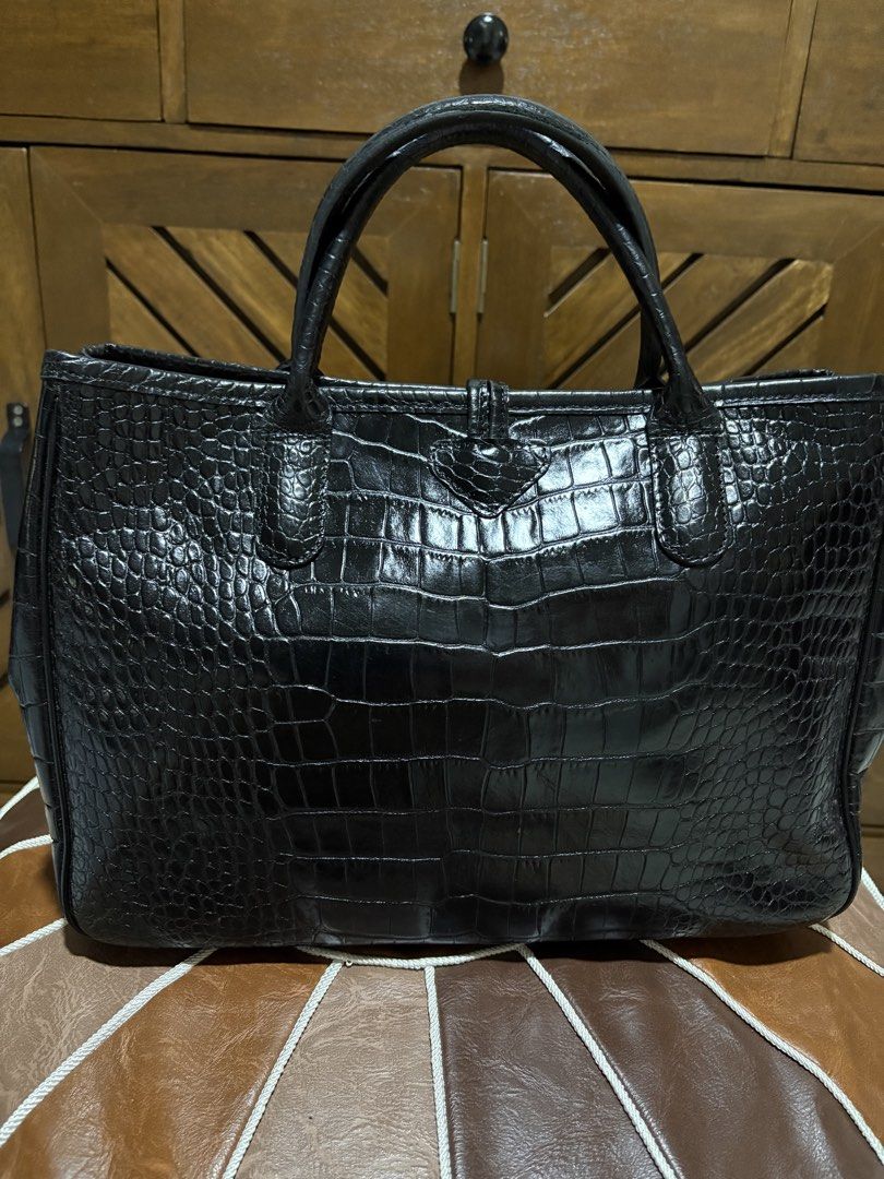 Longchamp Black Crocodile Embossed Leather Tote Bag (Category: Luxury Bags & Wallets) located in Paranaque City. Submitted by jnetpreloveditems (Listing ID 1440653517, Image 3). Description: - Luxurious black leather tote bag - Elegant crocodile embossed finish - Sturdy top handles for comfortable carrying - Secure central clasp closure - Surprise butterfly print interior lining - Structured design for a polished look - Versatile for daily errand