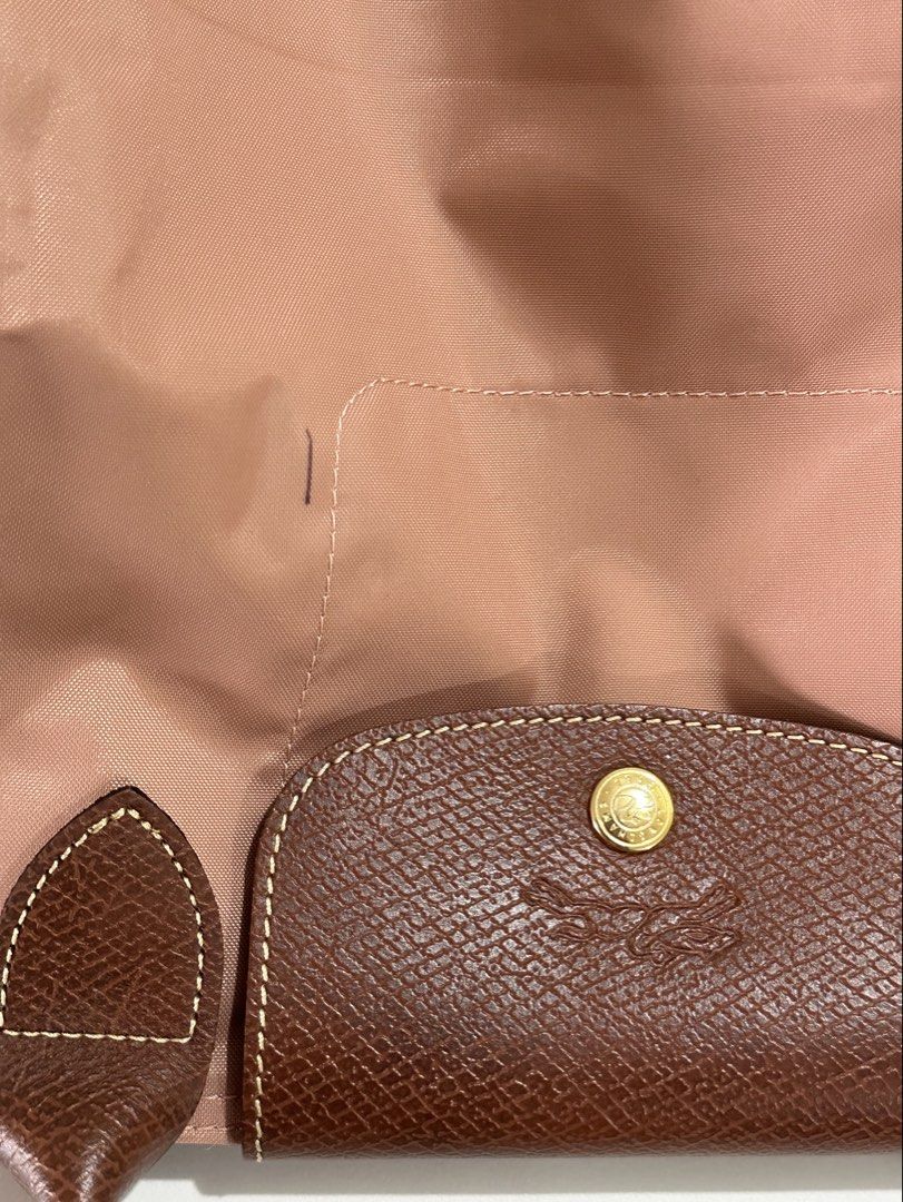 Longchamp Le Pliage Tote Bag Rose Pink (Category: Luxury Bags & Wallets) located in Quezon City. Submitted by jer01 (Listing ID 1440586398, Image 2). Description: Original Rose pink Longchamp Le Pliage tote bag with leather handles and trim. Includes original tag. Perfect for daily use or travel with its spacious interior. It has minimal flaws as u can see on the photos (pen mark, signs of usage) other than that the bag inside still clean and in 