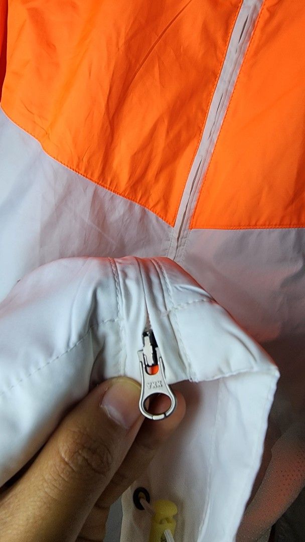 Nike Lightweight Running Jacket Orange White (Category: Coats, Jackets and Outerwear) located in Baguio. Submitted by chiechie1234 (Listing ID 1440591960, Image 3). Description: - Lightweight Nike running jacket - Full zip closure and two side pockets - Reflective details on sleeves for enhanced visibility - Breathable material with mesh sleeve lining - Ideal for running and casual wear.