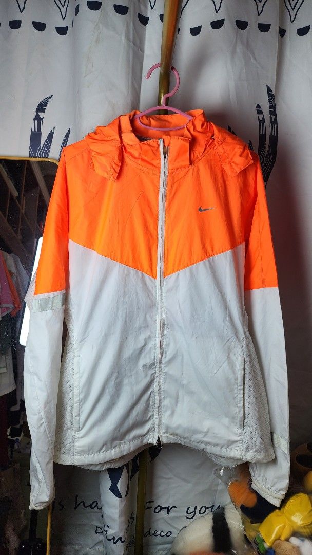 Nike Lightweight Running Jacket Orange White (Category: Coats, Jackets and Outerwear) located in Baguio. Submitted by chiechie1234 (Listing ID 1440591960, Image 1). Description: - Lightweight Nike running jacket - Full zip closure and two side pockets - Reflective details on sleeves for enhanced visibility - Breathable material with mesh sleeve lining - Ideal for running and casual wear.