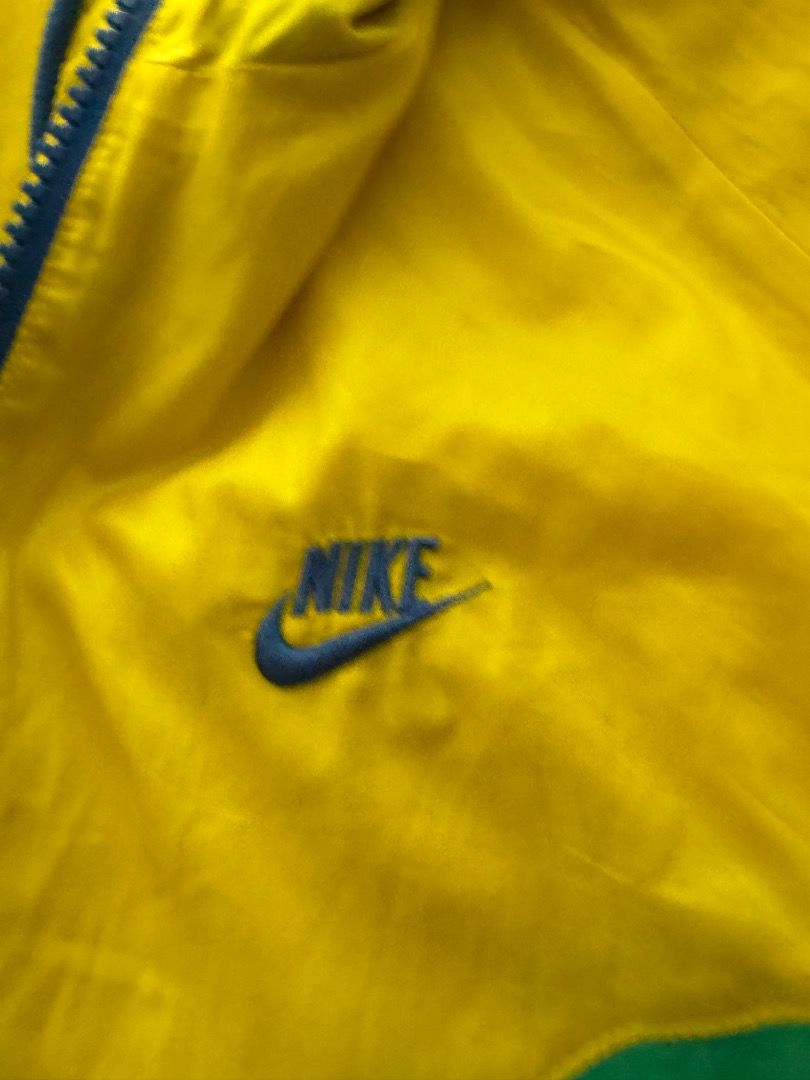 Nike Windbreaker Jacket Yellow Green Blue (Category: Coats, Jackets and Outerwear) located in Manila. Submitted by mypersonalclothes (Listing ID 1440708473, Image 2). Description: - Cool Nike windbreaker jacket - Bright yellow, green, and blue color block design - Full zip front with a hood - Two zip pockets on the front - Elastic cuffs and hem - Perfect for casual wear or sports.