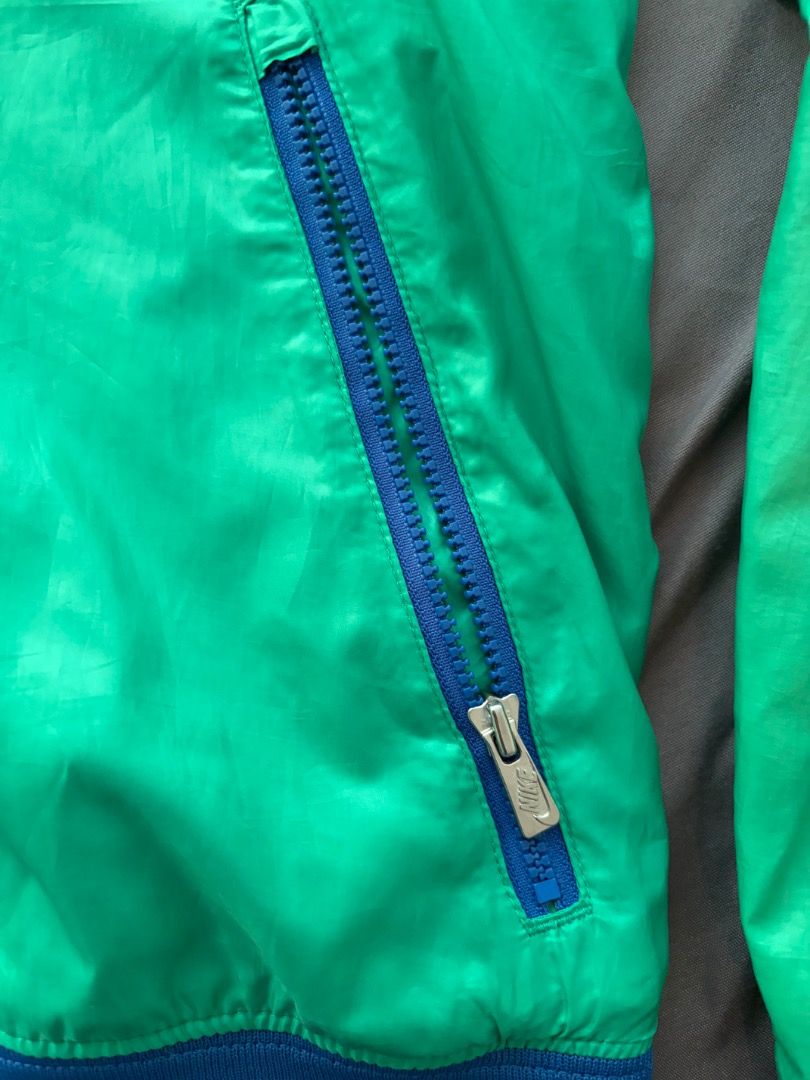 Nike Windbreaker Jacket Yellow Green Blue (Category: Coats, Jackets and Outerwear) located in Manila. Submitted by mypersonalclothes (Listing ID 1440708473, Image 3). Description: - Cool Nike windbreaker jacket - Bright yellow, green, and blue color block design - Full zip front with a hood - Two zip pockets on the front - Elastic cuffs and hem - Perfect for casual wear or sports.