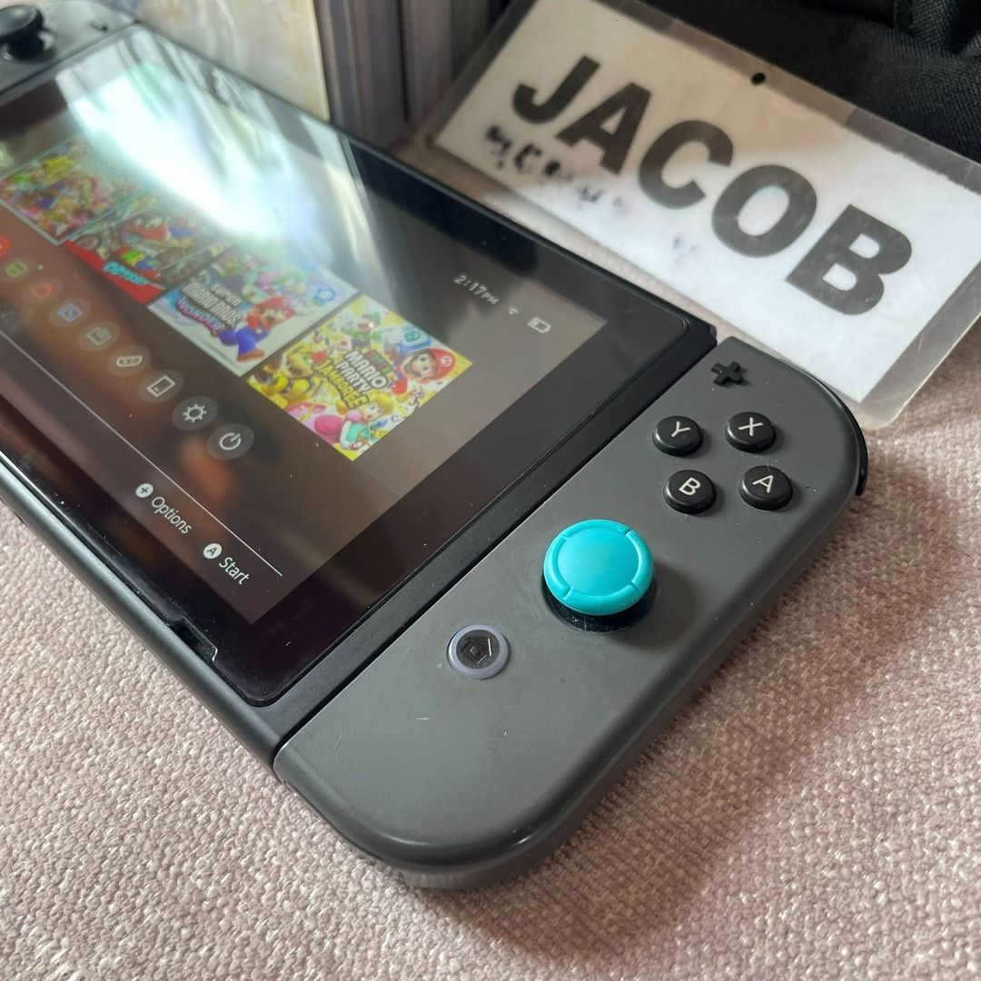 Nintendo Switch Version 2 / V2 Gray (Category: Nintendo) located in Pasig City. Submitted by zaphree (Listing ID 1440679591, Image 3). Description: Nintendo Switch Version 2 / V2 Gray UNIT + CARRYING CASE Inclusions ✅ Joy-Con (L) & Joy-Con (R) ✅ Switch device ✅ FREE Bag ✅ FREE Thumb Grips ✅ FREE Tempered Glass Price: 7,000 NO PERFORMANCE ISSUE. sa joycon stick pinalitan lang to blue. may free thumb grip covers naman na grey if ayaw mo sa blue. NO
