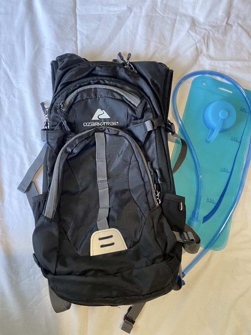 Ozark Trail Black Hiking Trekking Cycling Backpack with Hydration Bladder (Category: Backpacks) located in Quezon City. Submitted by closet-cleanup (Listing ID 1440666241, Image 1). Description: - Black Ozark Trail backpack - 23L capacity - Ideal for hiking, trekking, cycling - Multiple pockets for organized storage (4 zippered compartments, 2 open side compatments) - Padded back and straps for maximum comfort - Comes with a 2L blue hydration bla