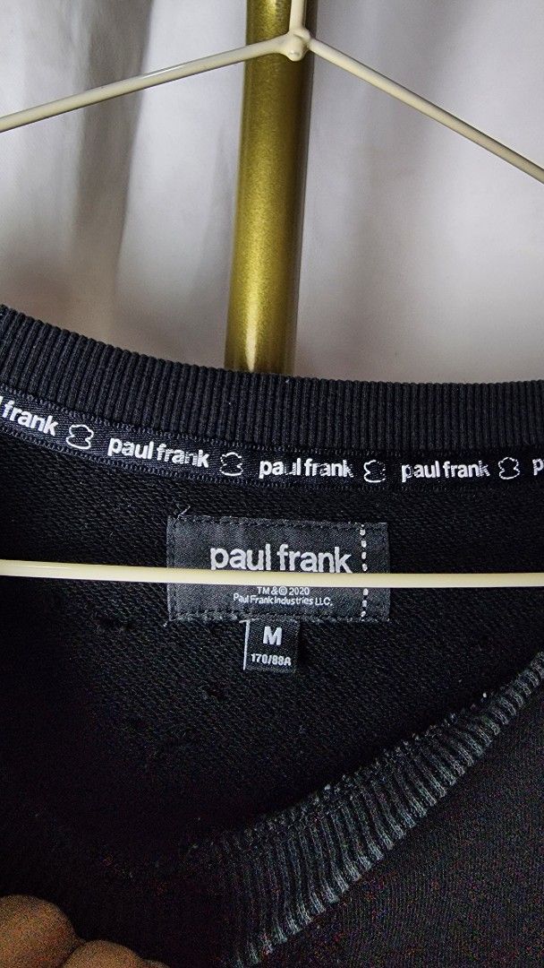 Paul Frank Black Monkey Skateboard Sweatshirt Size M (Category: Coats, Jackets and Outerwear) located in Baguio. Submitted by chiechie1234 (Listing ID 1440590329, Image 3). Description: - Brand: Paul Frank - Color: Black - Style: Long-sleeved sweatshirt - Size: Tagged M - Front Graphic: Iconic Julius monkey holding a skateboard - Back Graphic: Vertical stripes (yellow/red) with black lettering - Occasion: Casual wear.