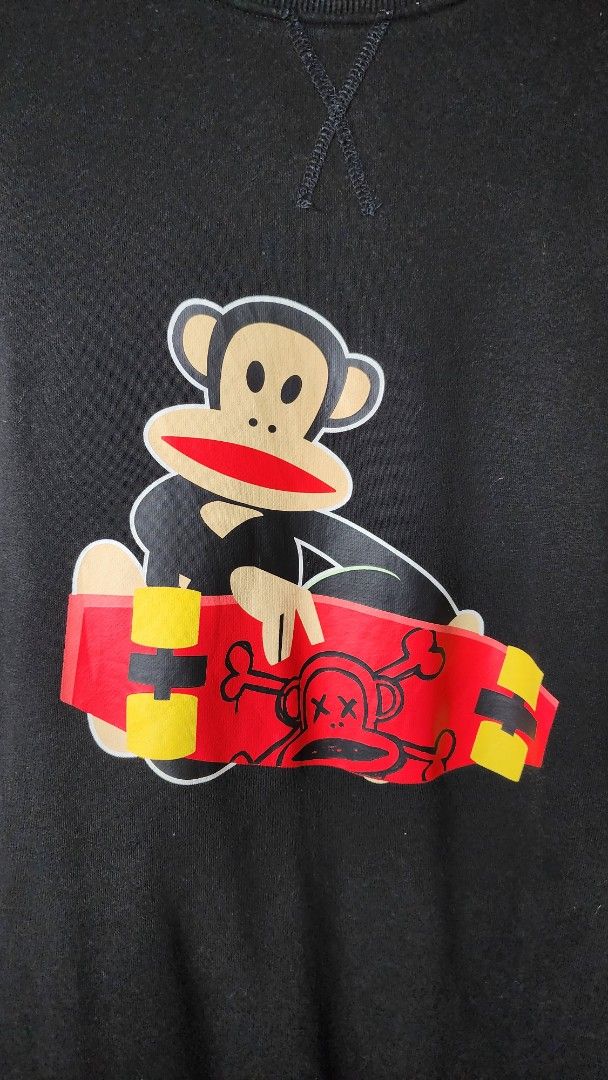 Paul Frank Black Monkey Skateboard Sweatshirt Size M (Category: Coats, Jackets and Outerwear) located in Baguio. Submitted by chiechie1234 (Listing ID 1440590329, Image 2). Description: - Brand: Paul Frank - Color: Black - Style: Long-sleeved sweatshirt - Size: Tagged M - Front Graphic: Iconic Julius monkey holding a skateboard - Back Graphic: Vertical stripes (yellow/red) with black lettering - Occasion: Casual wear.