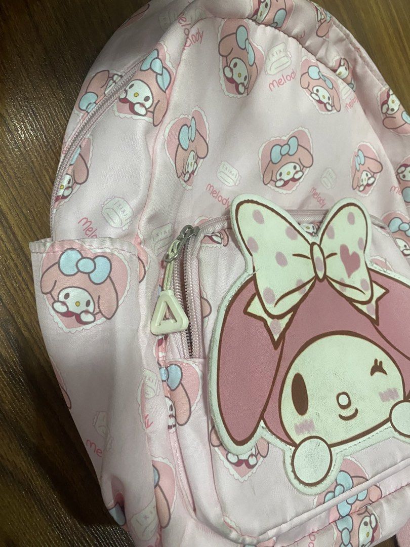 My Melody Kid’s Backpack (Category: Babies & Kids Fashion) located in Makati City. Submitted by ann.declutter (Listing ID 1440653789, Image 2). Description: - Adorable pink backpack featuring a repeating My Melody pattern. - Large My Melody applique on the front pocket. - Stylish silver-toned zippers. - Adjustable straps for a comfortable fit. - Ideal for school, travel, or everyday adventures..